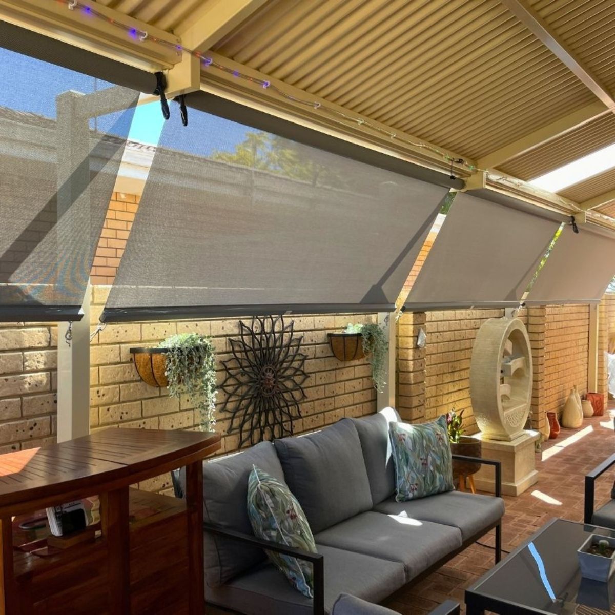 Crank and clip outdoor blinds installed on a Brisbane patio providing sun control and privacy while maintaining airflow