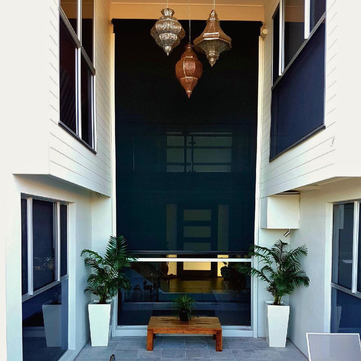 Outdoor blinds installed in a double height Brisbane home, demonstrating experienced design and precise installation in a complex architectural space