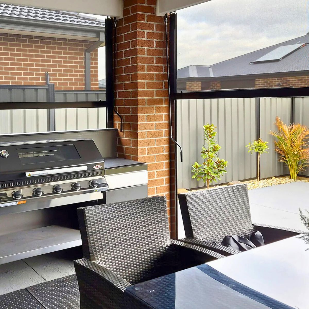 Outdoor blinds installed in a Brisbane outdoor kitchen and entertaining area, showing in house installation accountability and long term workmanship