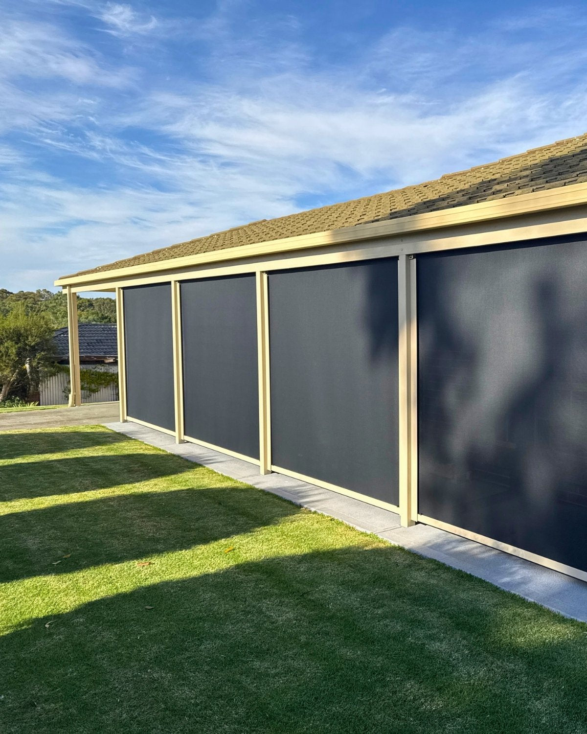 Custom outdoor blinds installed on a Brisbane backyard entertaining area.