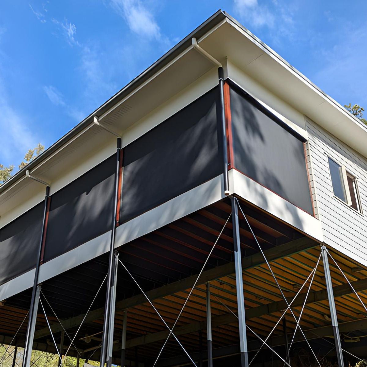 Outdoor blinds installed on an elevated Brisbane home, designed to withstand harsh Australian sun wind storms and coastal conditions