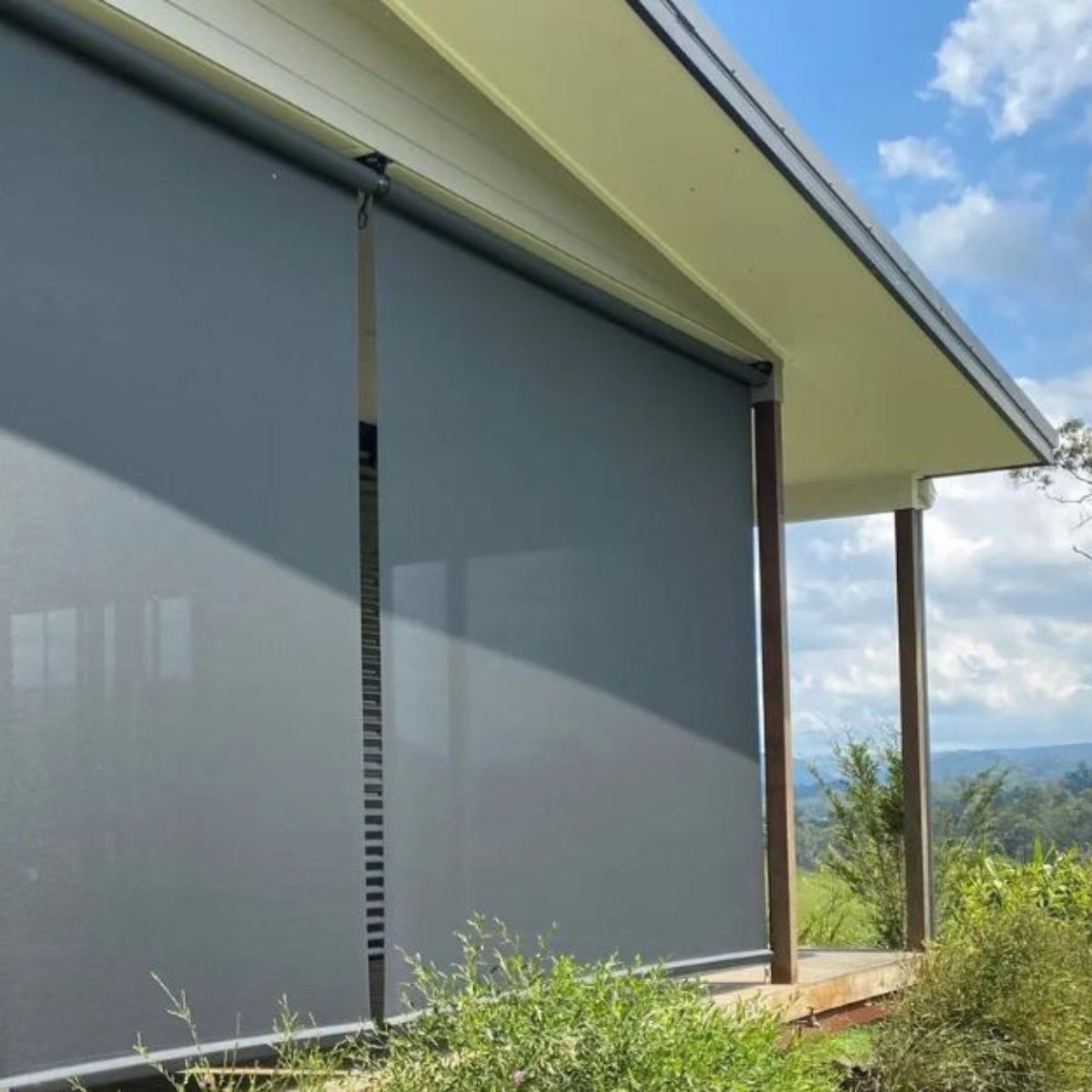 Outdoor blinds installed on a Brisbane home blocking harsh sun and heat while maintaining airflow and views