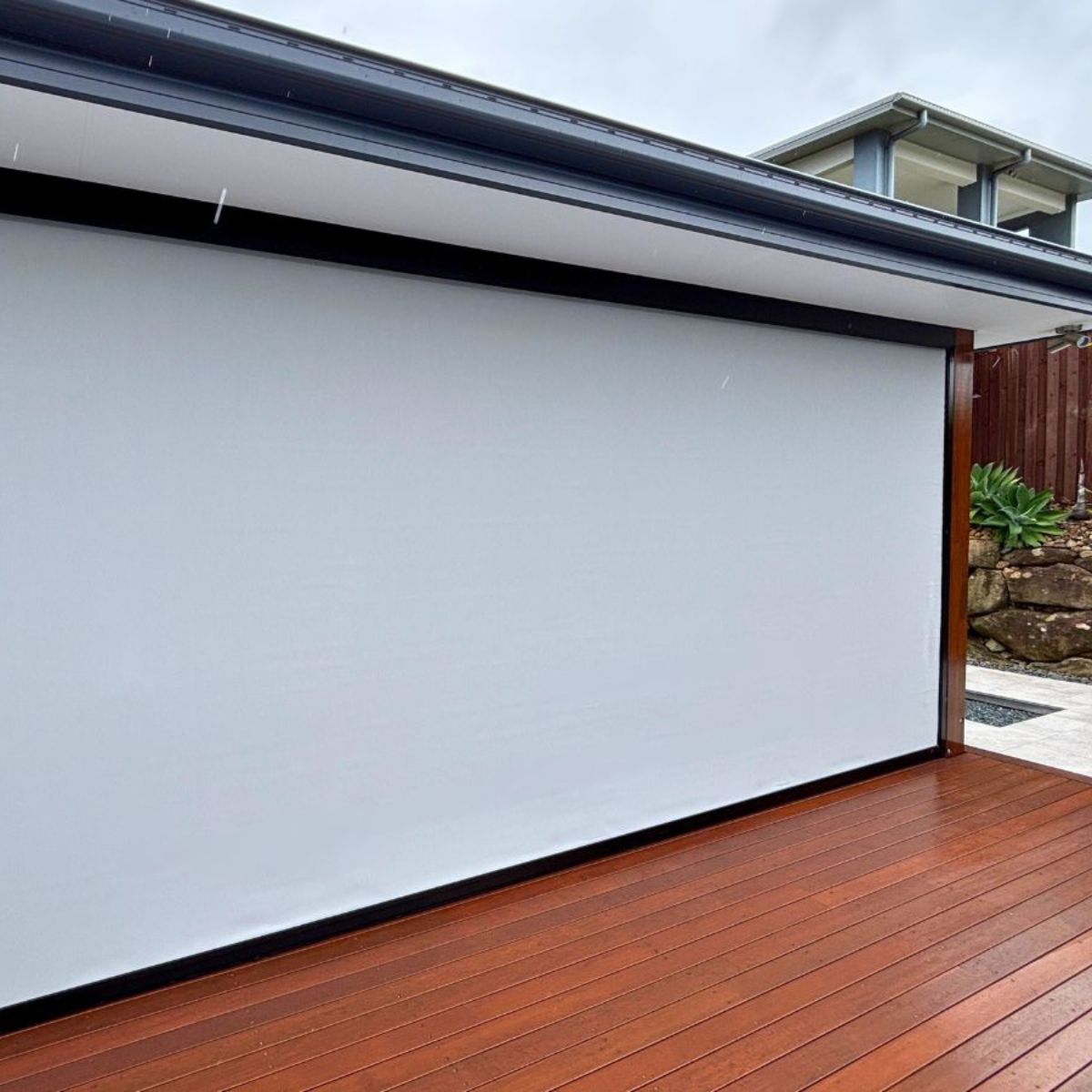 Outdoor blinds installed on a Brisbane patio protecting the area from wind and driving rain