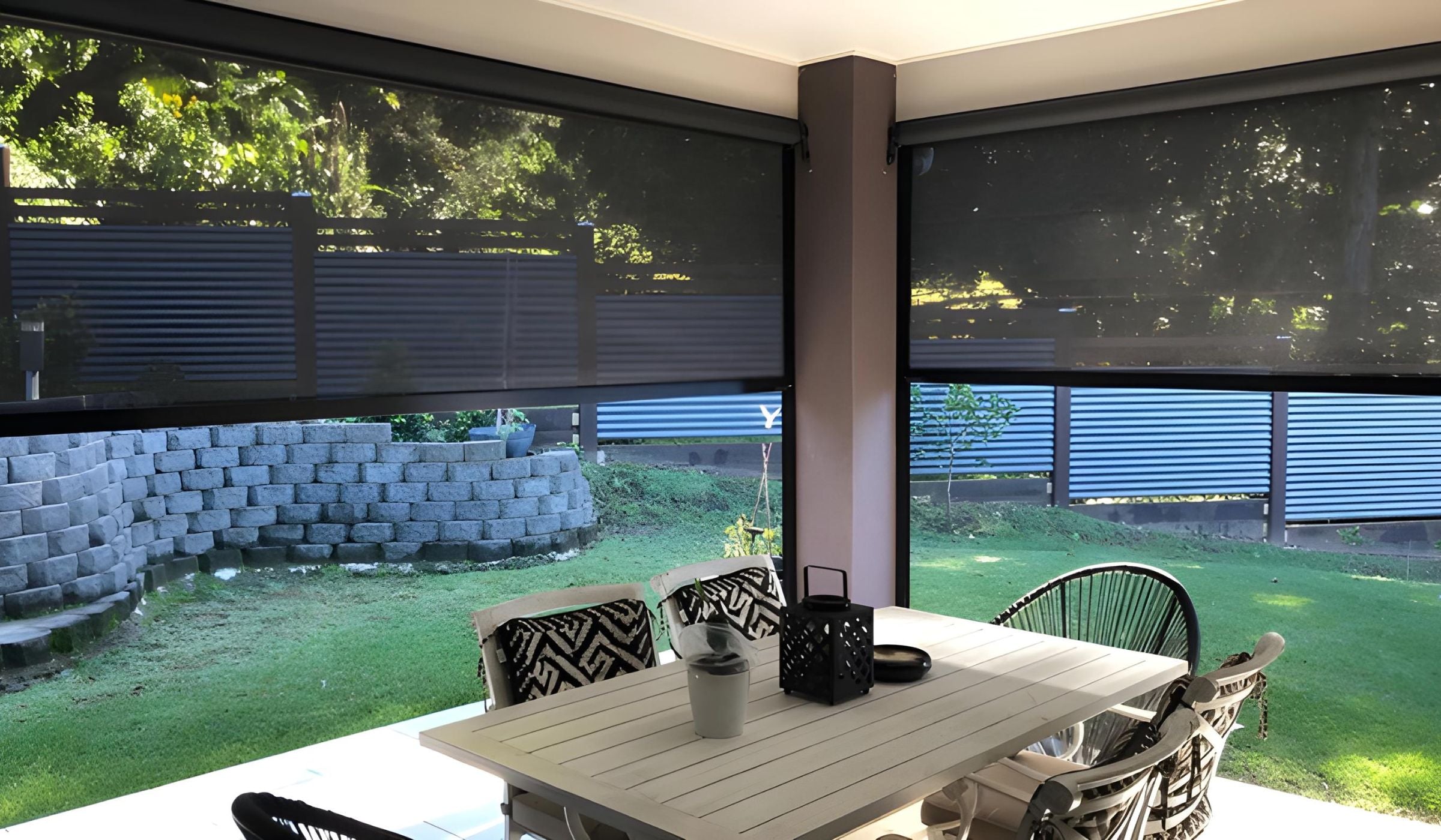 Custom outdoor blinds installed on a modern Brisbane patio, providing shade, privacy and protection from sun, wind and rain with professional measure and installation.